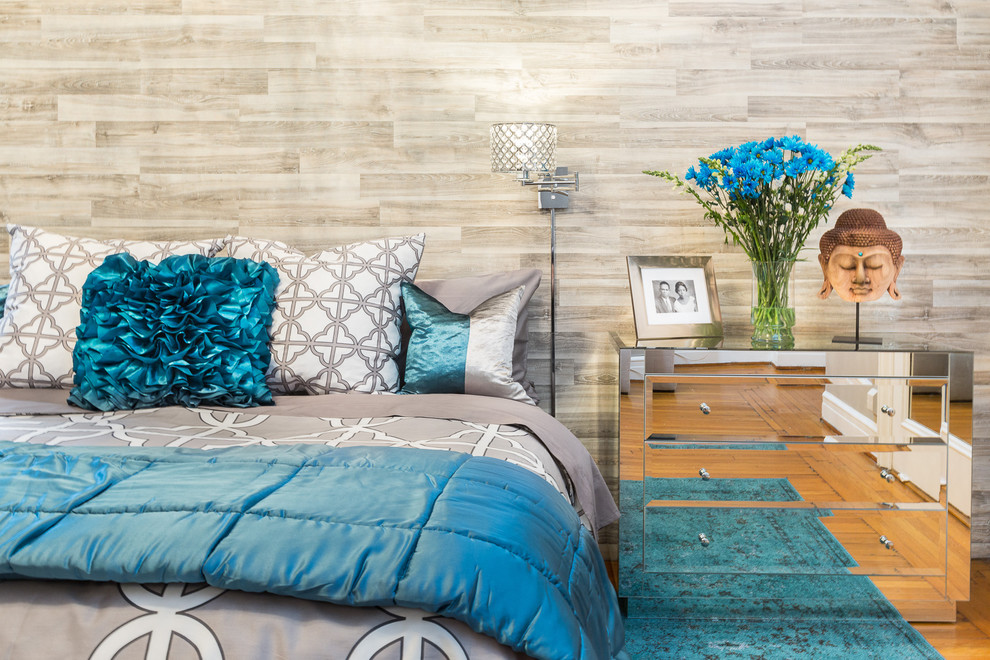 Large modern master bedroom in New York with grey walls and light hardwood floors.