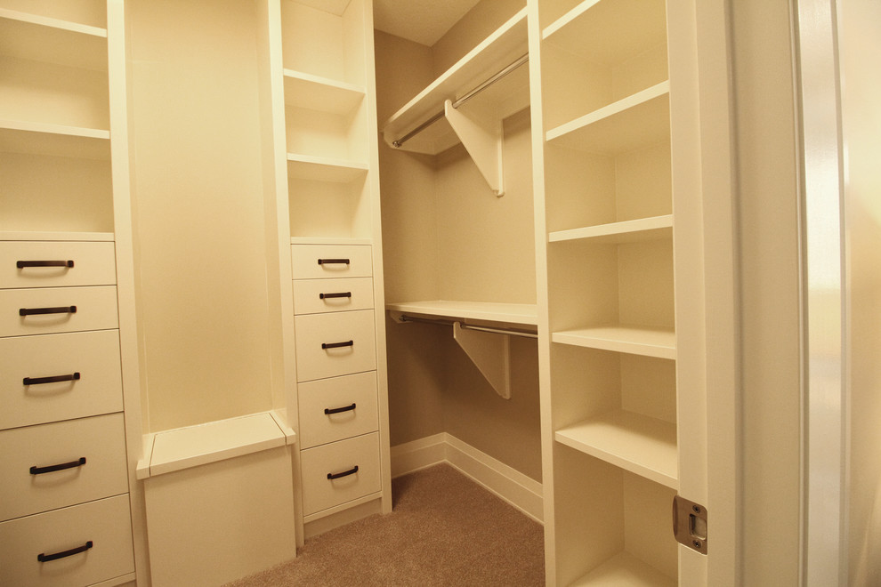 Inspiration for a mid-sized country gender-neutral walk-in wardrobe in Calgary with open cabinets, white cabinets and carpet.