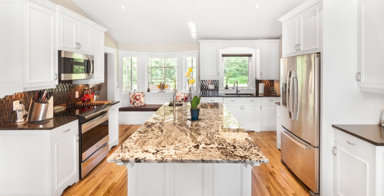 Example of a mid-sized transitional u-shaped light wood floor eat-in kitchen design with an undermount sink, raised-panel cabinets, white cabinets, quartzite countertops, metallic backsplash, mosaic tile backsplash, stainless steel appliances and an island