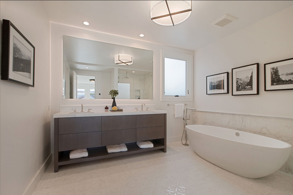 Photo of a large contemporary master bathroom in San Francisco with flat-panel cabinets, dark wood cabinets, a freestanding tub, an alcove shower, a two-piece toilet, white tile, marble, white walls, marble floors, an undermount sink, marble benchtops, white floor, a hinged shower door and white benchtops.