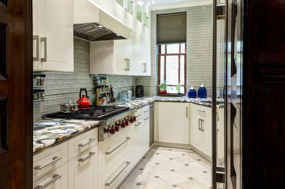 Small galley separate kitchen in New York with an undermount sink, flat-panel cabinets, white cabinets, quartz benchtops, grey splashback, glass tile splashback, stainless steel appliances, marble floors and no island.