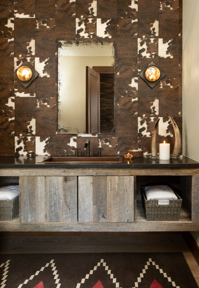 Inspiration for a country bathroom in Other with open cabinets, multi-coloured walls, a drop-in sink and black benchtops.