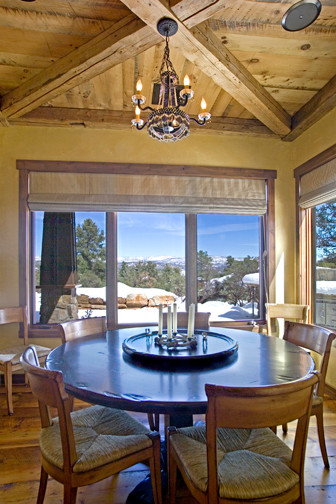 Huge mountain style medium tone wood floor enclosed dining room photo in Phoenix with beige walls