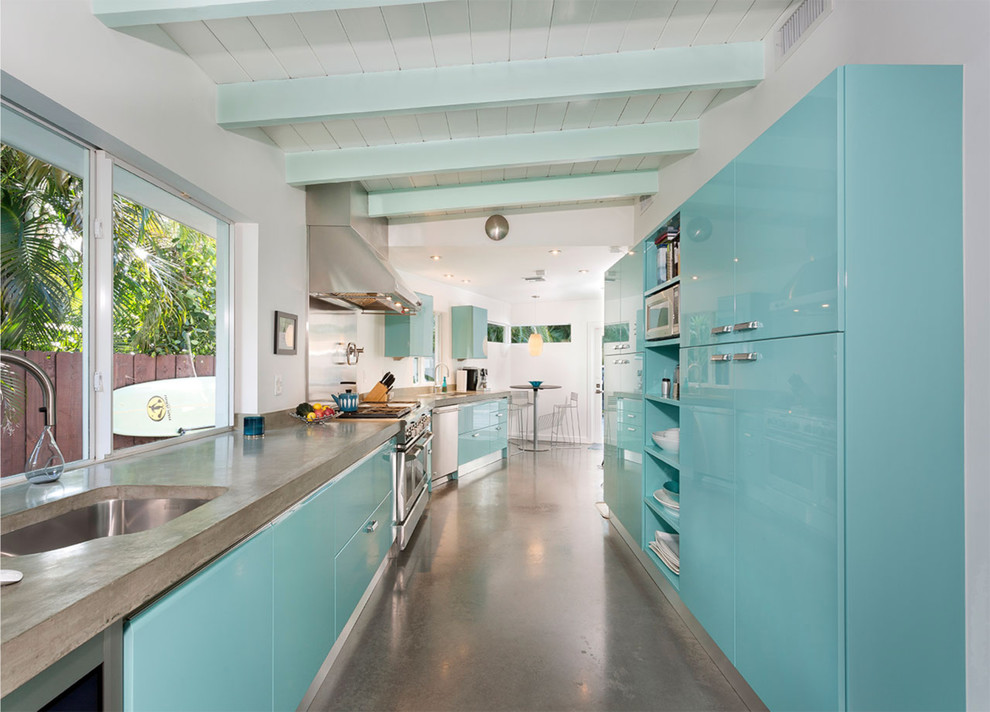 Design ideas for a mid-sized midcentury galley eat-in kitchen in Miami with an undermount sink, flat-panel cabinets, turquoise cabinets, concrete benchtops, concrete floors, grey floor, grey benchtop, stainless steel appliances and no island.