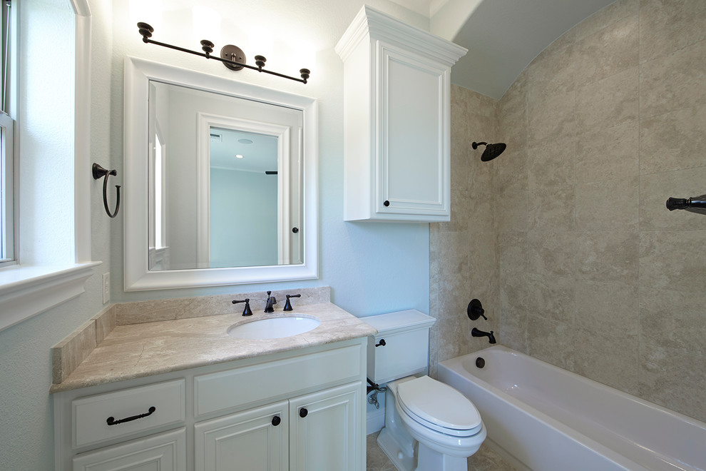 Inspiration for a transitional bathroom in Dallas with recessed-panel cabinets, white cabinets, a drop-in tub, a shower/bathtub combo, white walls and an undermount sink.