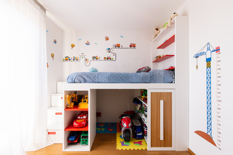 Design ideas for a small contemporary kids' bedroom for kids 4-10 years old and boys in Milan with white walls and light hardwood floors.