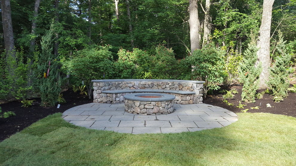 Photo of a mid-sized country backyard patio in Boston with a fire feature and natural stone pavers.