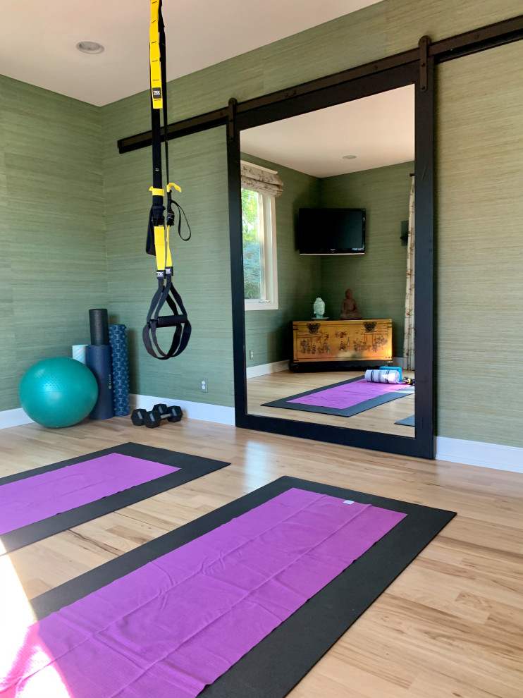 This is an example of a home gym in San Francisco with light hardwood floors.