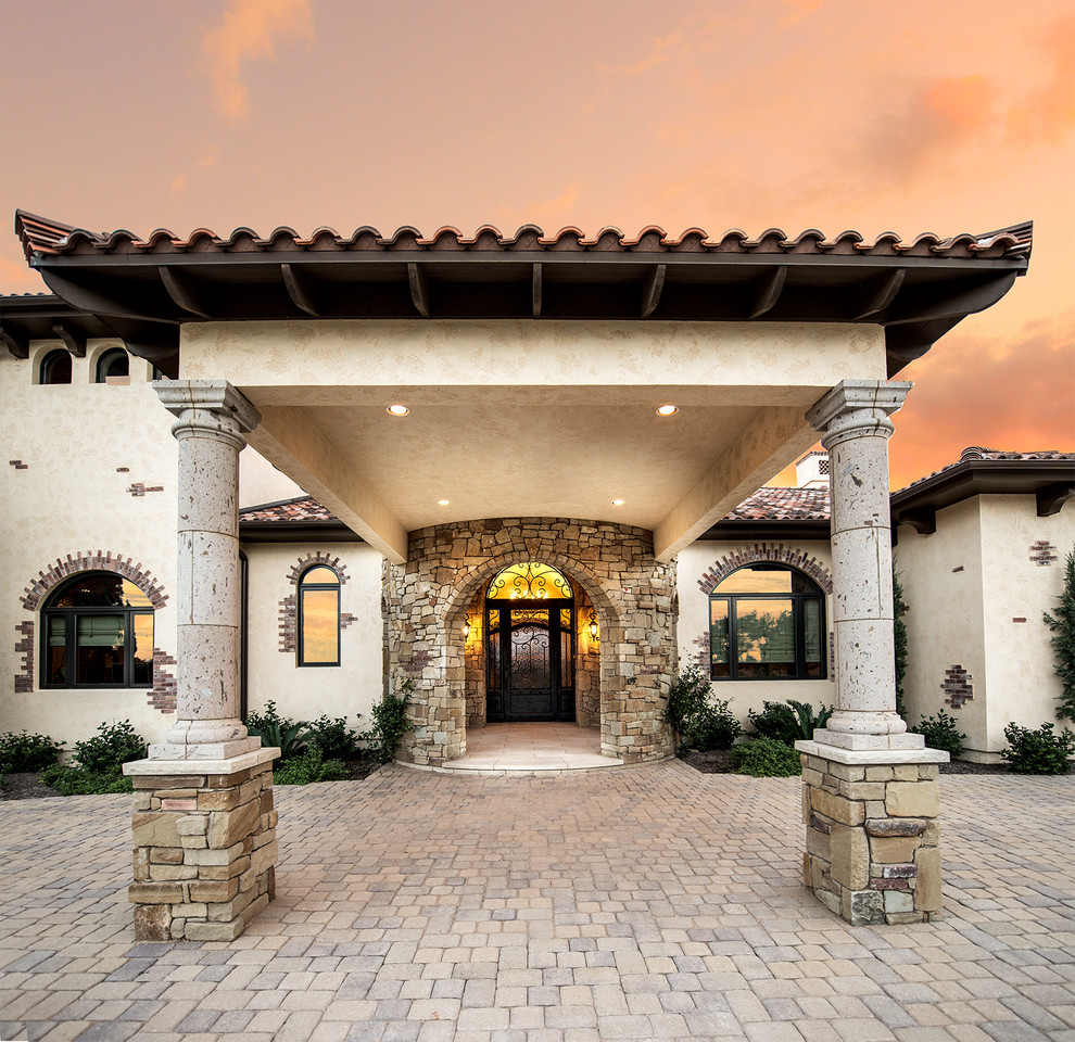 Inspiration for an expansive mediterranean entryway in Austin with beige walls and a single front door.