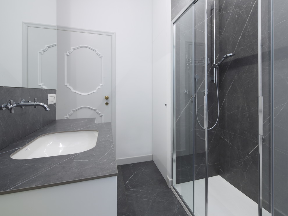 Photo of a modern bathroom in Other with gray tile, porcelain tile, white walls, porcelain floors, grey floor, a hinged shower door and grey benchtops.