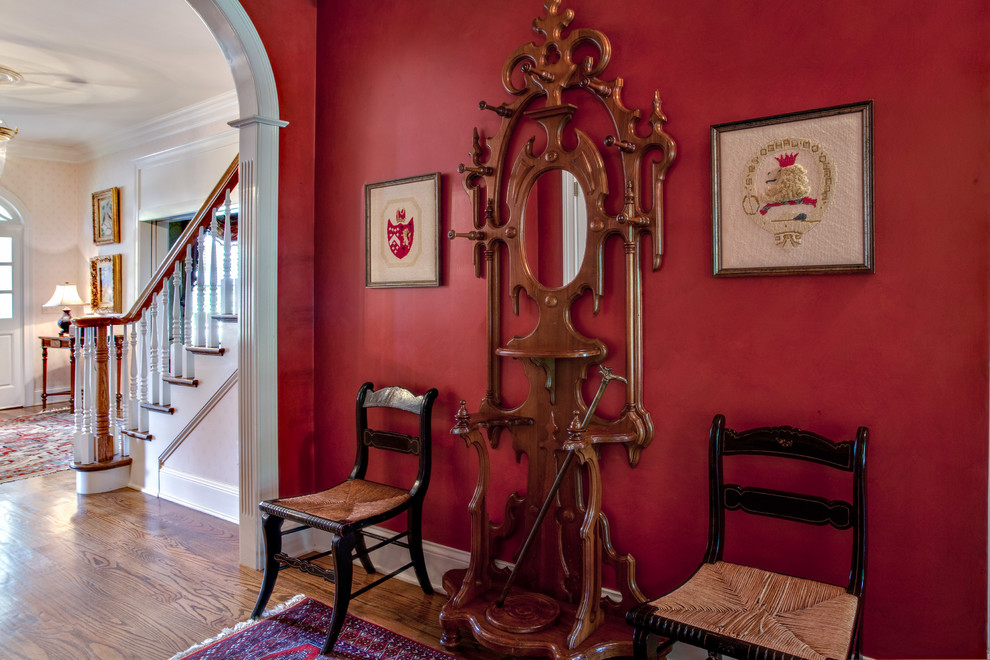 Photo of a mid-sized traditional hallway in Nashville with red walls and medium hardwood floors.