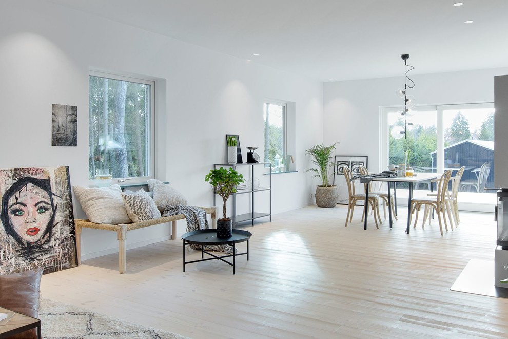 Mid-sized scandinavian family room in Stockholm with white walls, painted wood floors and white floor.