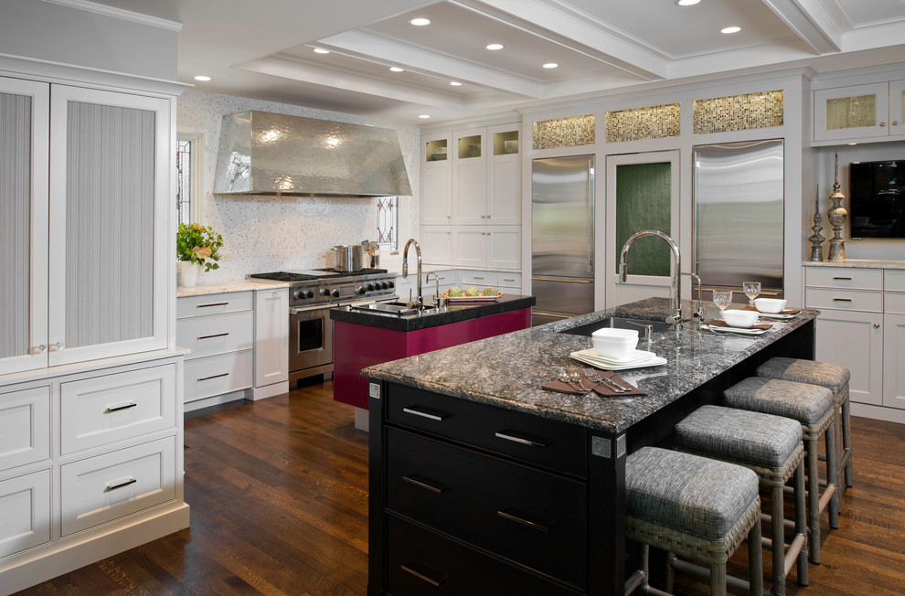 This is an example of a transitional kitchen in Chicago with an undermount sink, beaded inset cabinets, white cabinets, granite benchtops, white splashback, mosaic tile splashback and stainless steel appliances.