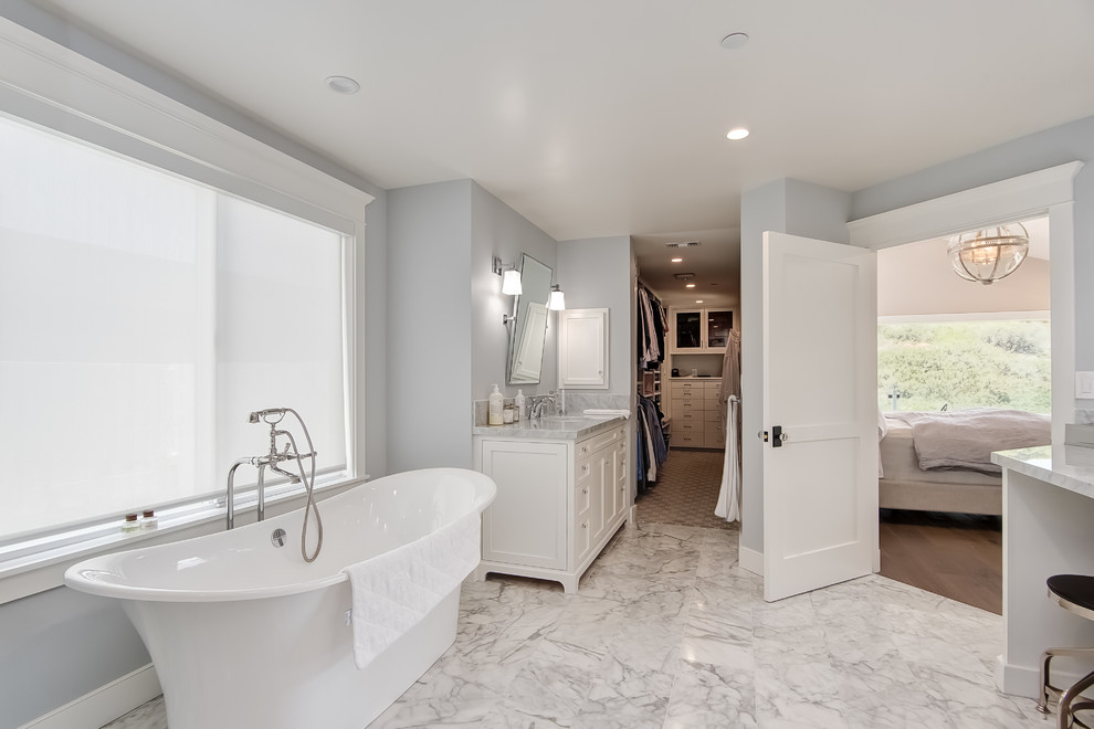 Photo of a large beach style master bathroom in Orange County with recessed-panel cabinets.