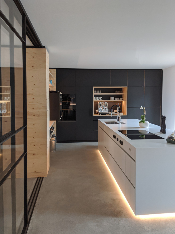 Design ideas for a large industrial kitchen in Essen with flat-panel cabinets, black cabinets and with island.