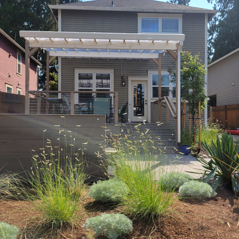Photo of a medium sized modern back xeriscape full sun garden for summer in Portland with a pathway and decking.