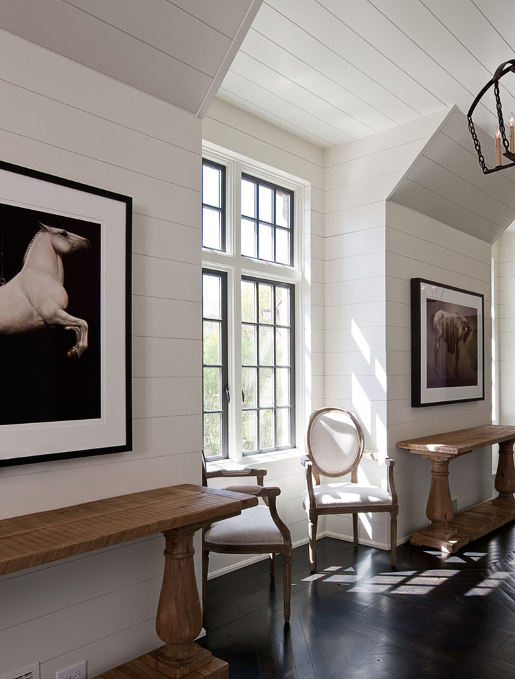 This is an example of a mid-sized traditional hallway in Atlanta with white walls, dark hardwood floors and brown floor.