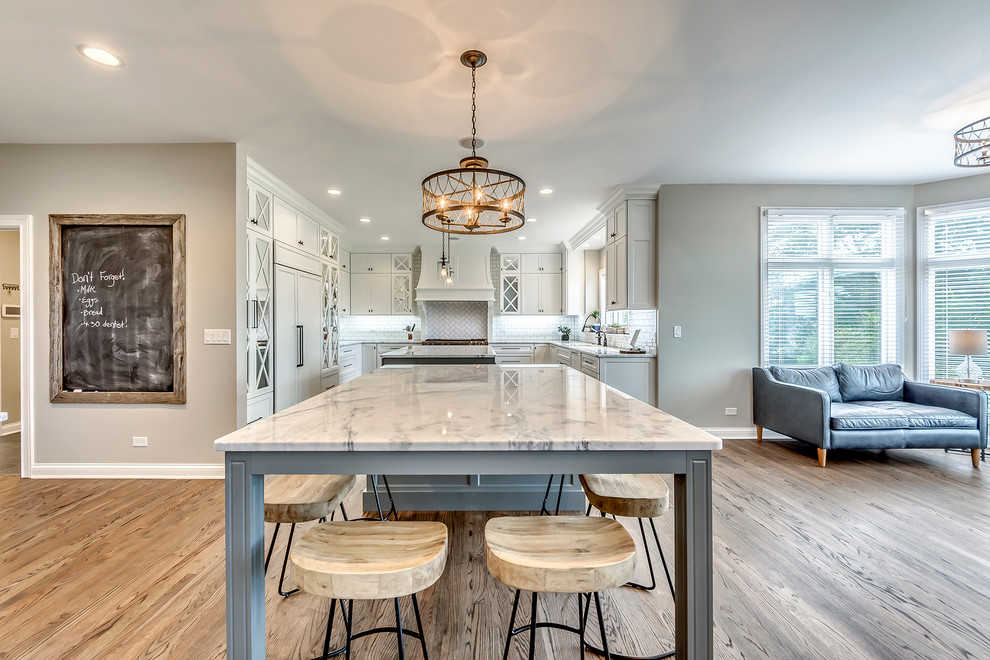 Open concept kitchen - transitional open concept kitchen idea in Chicago with white backsplash, subway tile backsplash and two islands