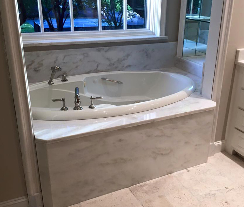 Inspiration for a mid-sized transitional master ceramic tile drop-in bathtub remodel in Dallas with white cabinets, white walls and marble countertops