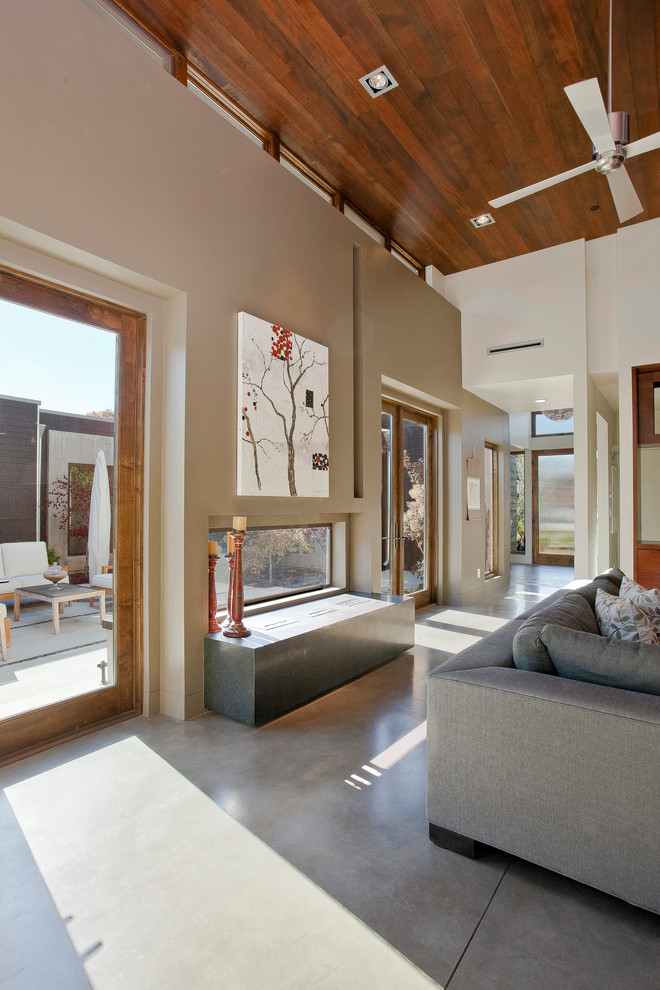 This is an example of a modern living room in San Francisco with concrete floors.