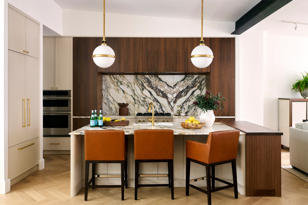 Large transitional l-shaped light wood floor, beige floor, exposed beam and vaulted ceiling open concept kitchen photo in Philadelphia with flat-panel cabinets, marble countertops, multicolored backsplash, marble backsplash, paneled appliances, an island, multicolored countertops, an undermount sink and brown cabinets