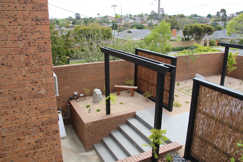 Small asian front yard partial sun formal garden in Melbourne with a garden path and gravel for spring.