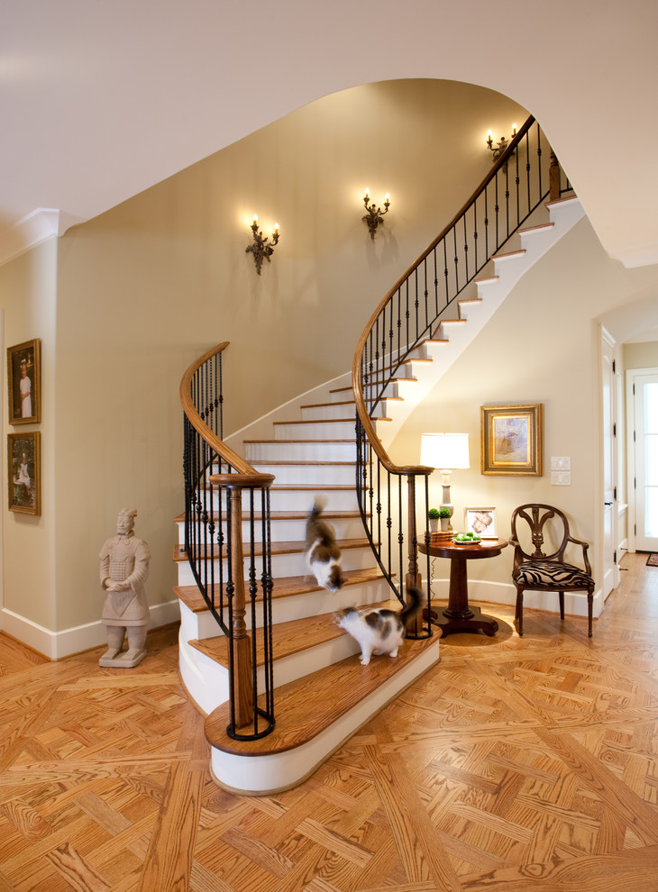 Design ideas for a large traditional wood curved staircase in Houston with wood risers.