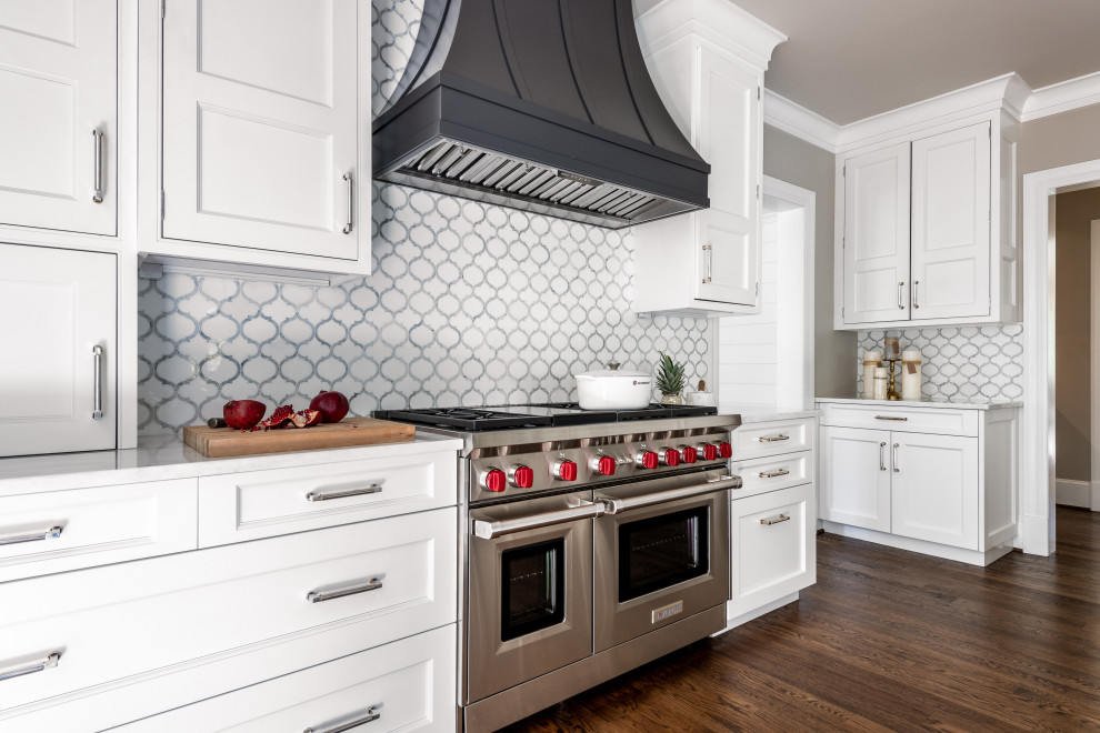 Design ideas for a mid-sized transitional kitchen in DC Metro with a drop-in sink, flat-panel cabinets, white cabinets, marble benchtops, white splashback, marble splashback, stainless steel appliances, dark hardwood floors, multiple islands, brown floor and white benchtop.