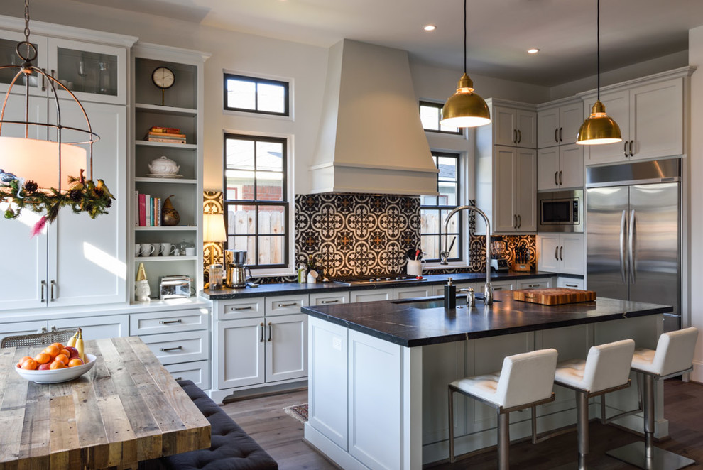 Inspiration for a large transitional l-shaped eat-in kitchen in Houston with an undermount sink, shaker cabinets, white cabinets, soapstone benchtops, multi-coloured splashback, cement tile splashback, stainless steel appliances, medium hardwood floors and with island.