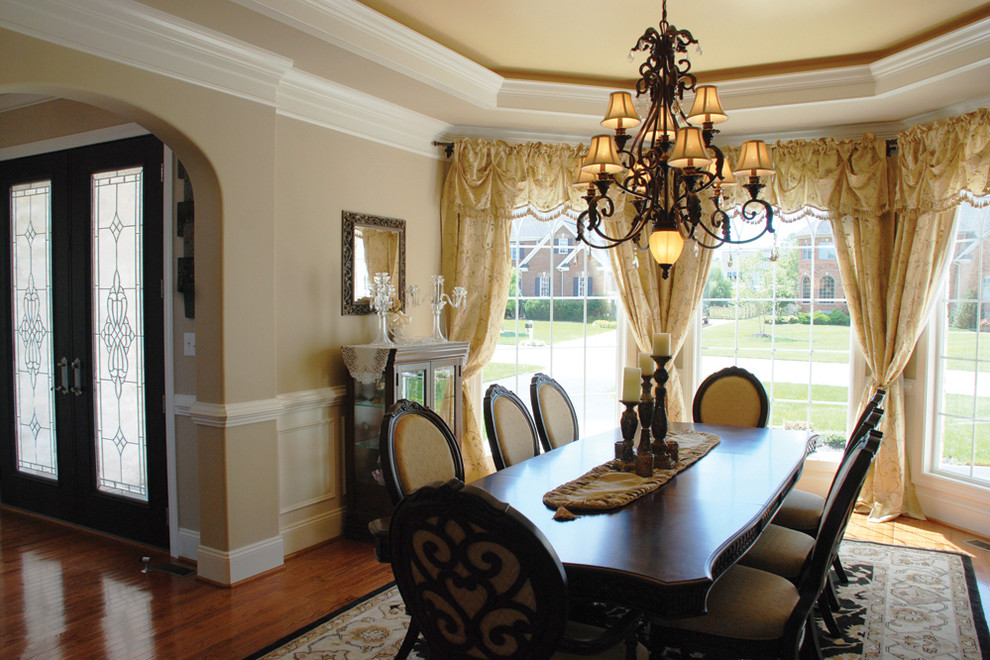 Inspiration for a mid-sized transitional medium tone wood floor enclosed dining room remodel in Richmond with beige walls and no fireplace