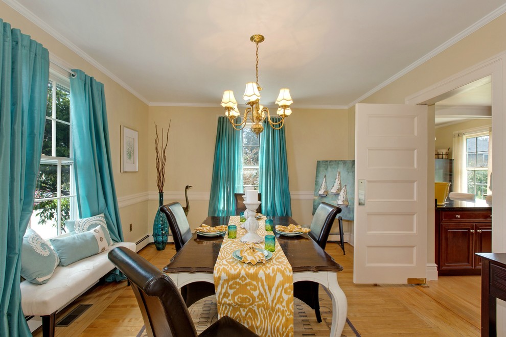This is an example of a mid-sized traditional separate dining room in New York with beige walls and light hardwood floors.