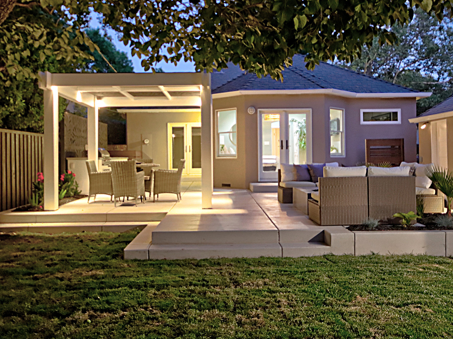 Inviting Raised Patio with Custom Pergola and Gate