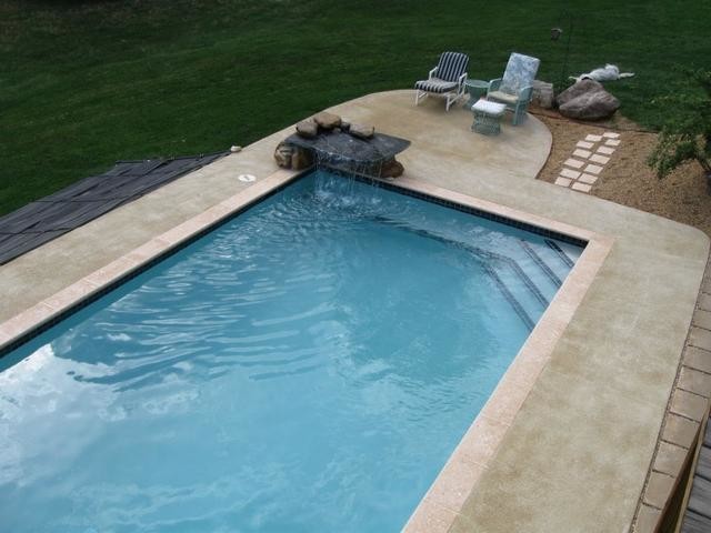 Large backyard brick and custom-shaped aboveground pool fountain photo