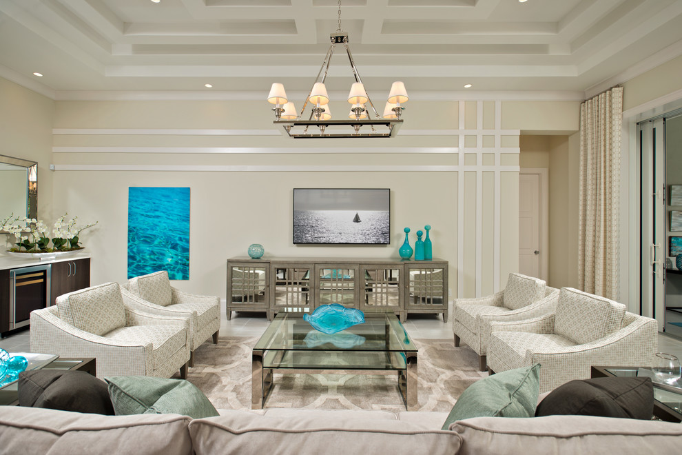 Photo of a tropical family room in Miami with a home bar and beige walls.
