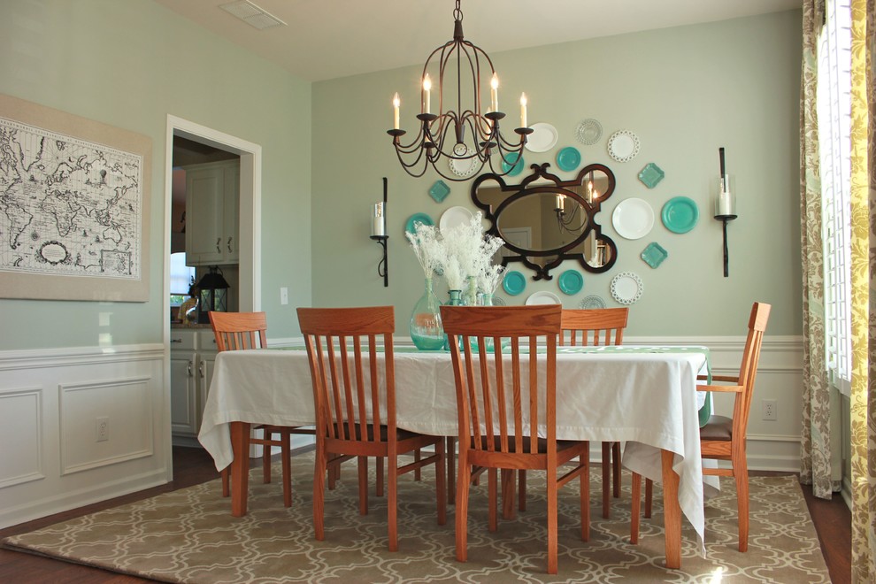 Design ideas for a traditional separate dining room in Charlotte with dark hardwood floors and green walls.