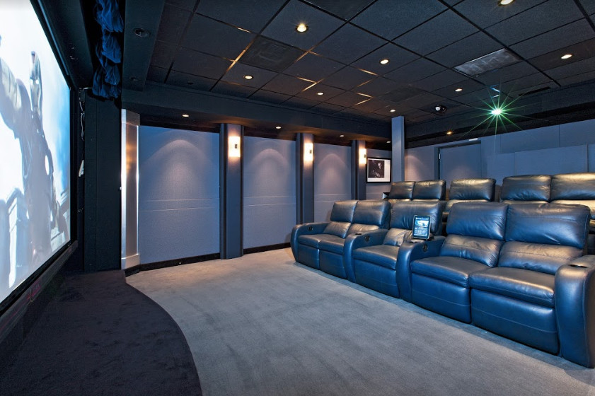Design ideas for a large transitional enclosed home theatre in Denver with blue walls, carpet, a projector screen and grey floor.