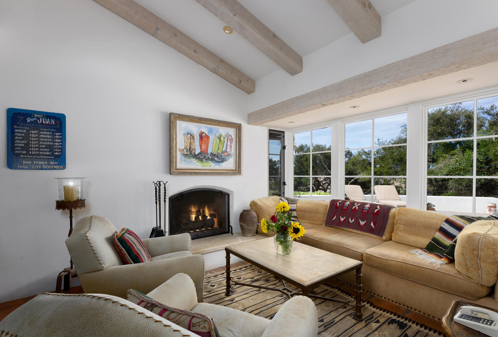 Design ideas for a formal enclosed living room in Santa Barbara with white walls, a standard fireplace, a plaster fireplace surround and no tv.