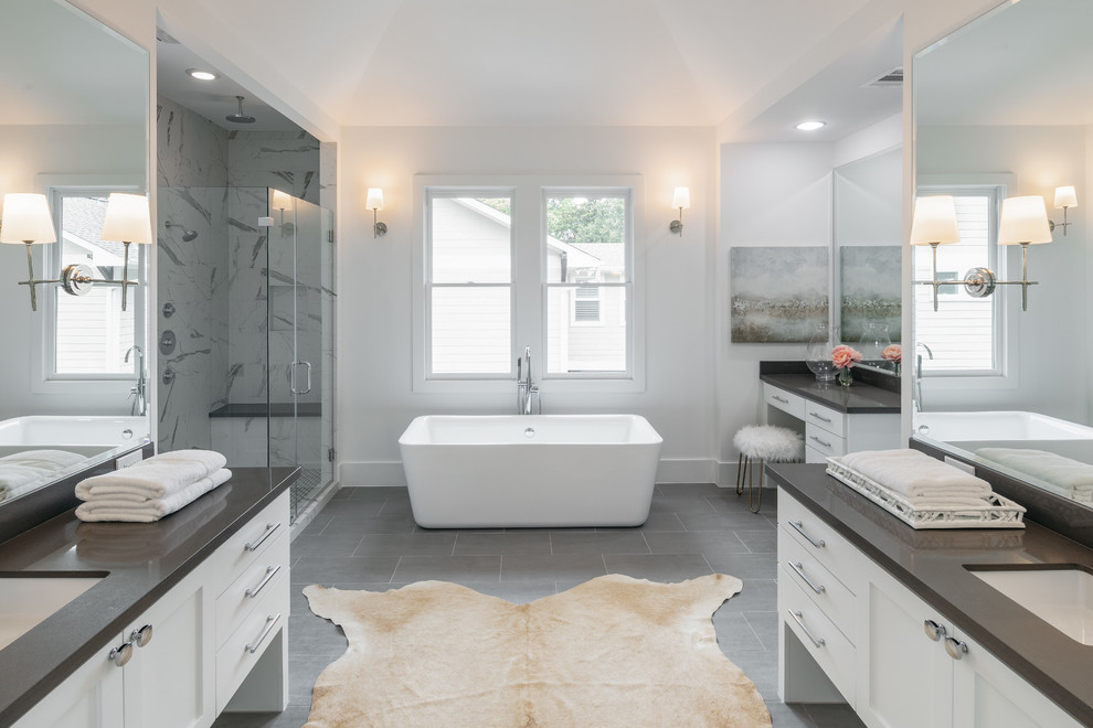 Design ideas for a large transitional master bathroom in Houston with shaker cabinets, white cabinets, a freestanding tub, ceramic floors, an undermount sink, grey floor, a hinged shower door, grey benchtops, white walls, gray tile, a double vanity and a built-in vanity.