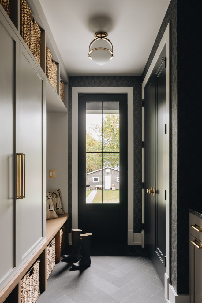 Example of a transitional gray floor and wallpaper entryway design in Chicago with gray walls and a black front door