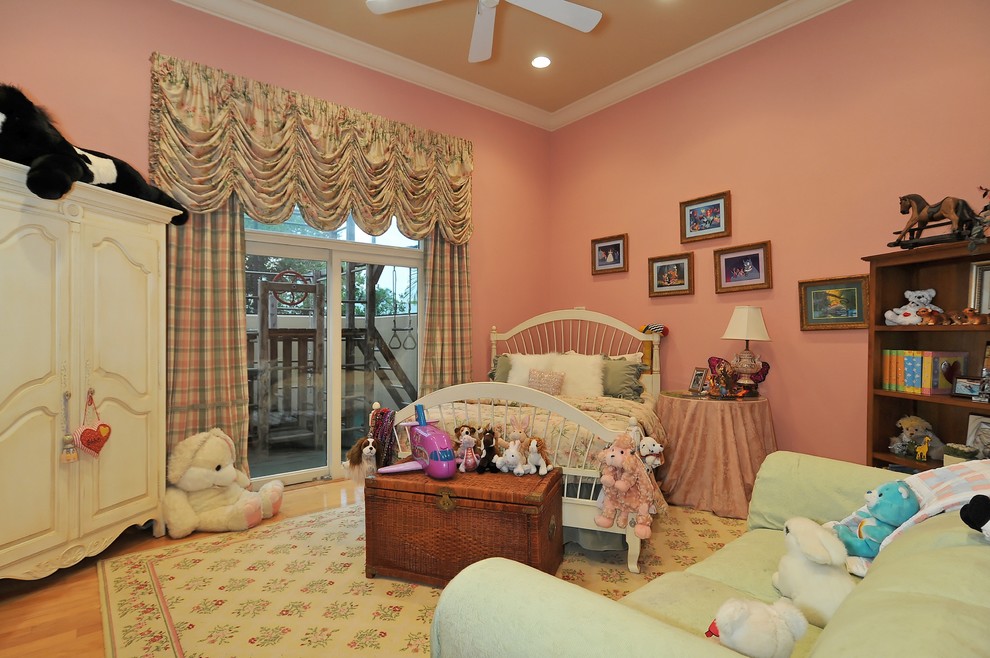 Traditional kids' room in Tampa with pink walls.
