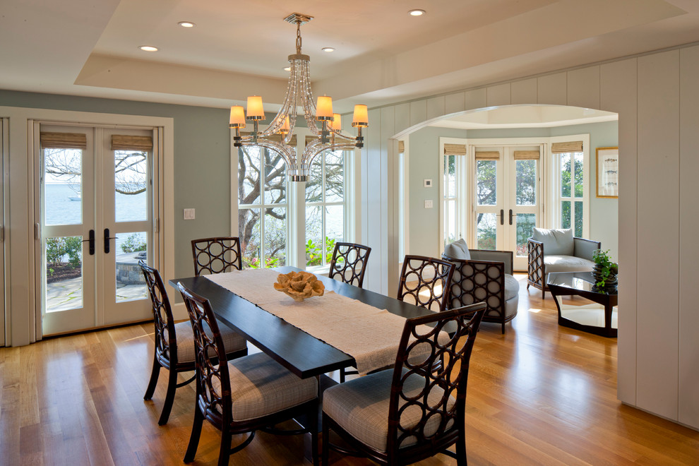 This is an example of a traditional dining room in Boston with blue walls and medium hardwood floors.