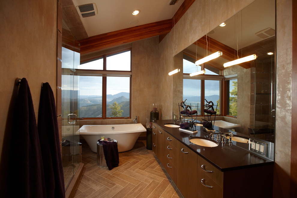 Inspiration for a contemporary master bathroom in Minneapolis with a freestanding tub, flat-panel cabinets, dark wood cabinets, an alcove shower, brown walls, porcelain floors, an undermount sink, quartzite benchtops and a hinged shower door.