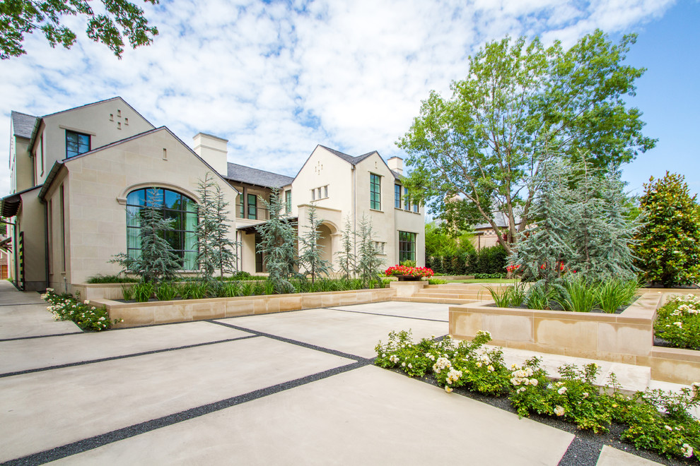 Photo of a mid-sized contemporary front yard full sun driveway for spring in Dallas with a garden path and natural stone pavers.