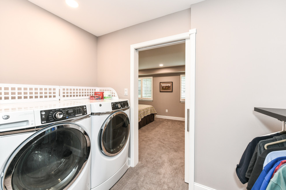 Photo of a mid-sized traditional single-wall utility room in DC Metro with grey walls, carpet and beige floor.
