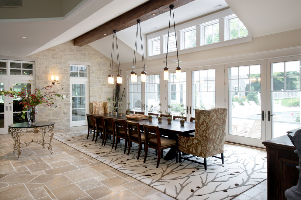 This is an example of a large traditional open plan dining in Milwaukee with beige walls, travertine floors, no fireplace and beige floor.