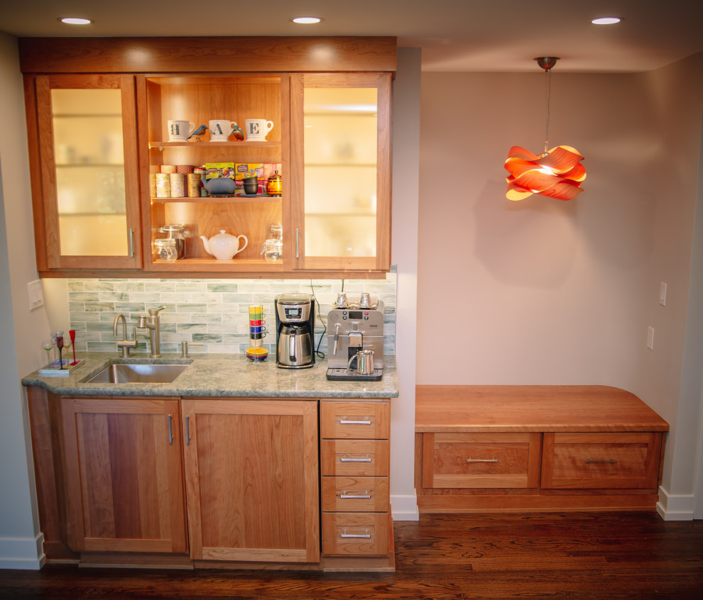 Inspiration for a mid-sized midcentury single-wall wet bar in Other with an undermount sink, glass-front cabinets, medium wood cabinets, quartzite benchtops, green splashback, subway tile splashback, medium hardwood floors, brown floor and green benchtop.