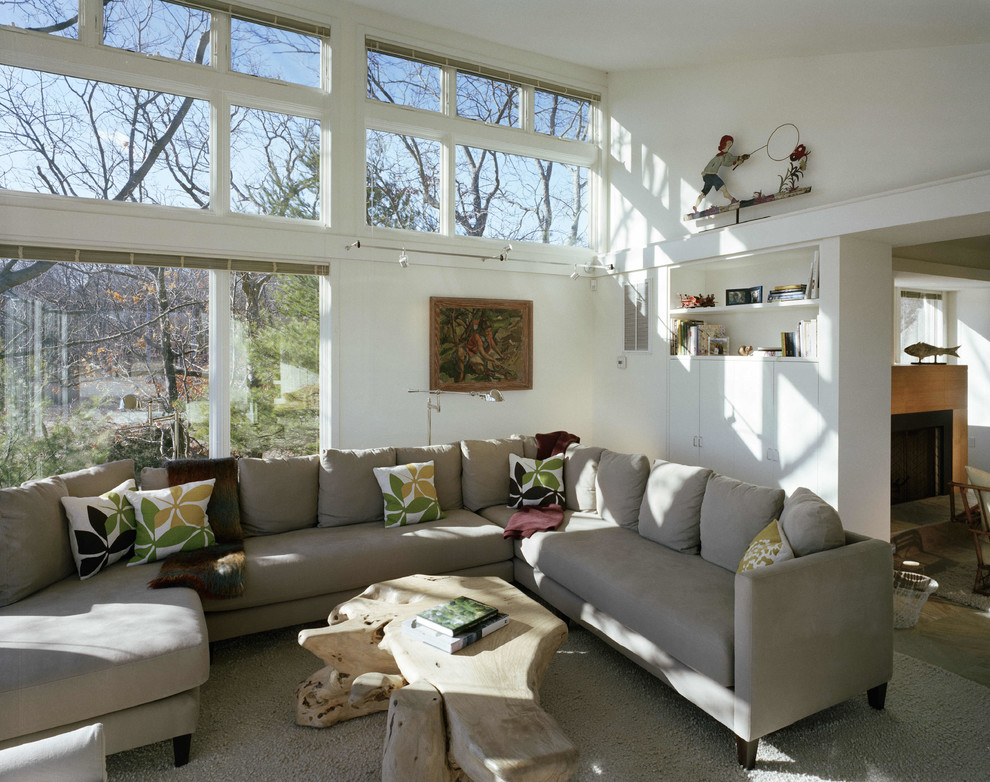 This is an example of a contemporary living room in New York with white walls.