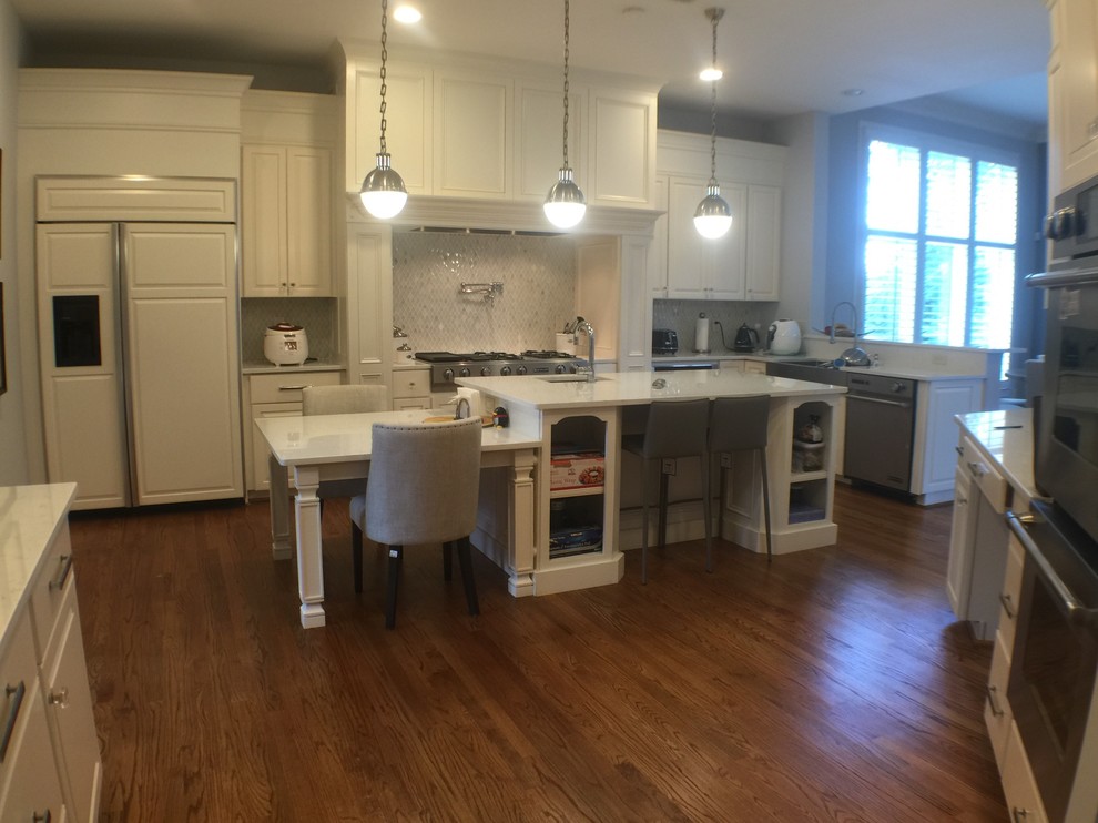 Inspiration for a large transitional u-shaped medium tone wood floor open concept kitchen remodel in DC Metro with an undermount sink, raised-panel cabinets, white cabinets, quartzite countertops, stainless steel appliances and an island