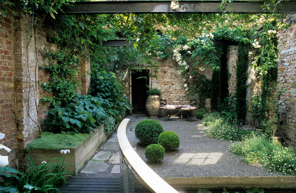 Industrial courtyard patio in London with gravel, no cover and a vertical garden.