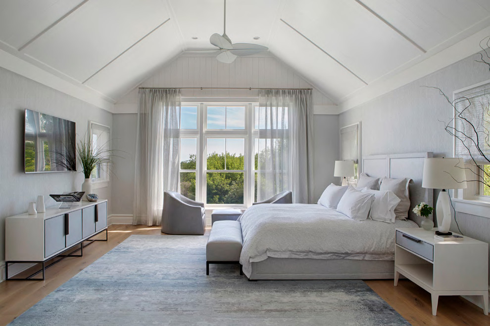 Inspiration for a transitional master bedroom in New York with grey walls, medium hardwood floors and brown floor.